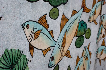 Painted fish on the wall Temple Bangnon in Ranong,Thailandの写真素材