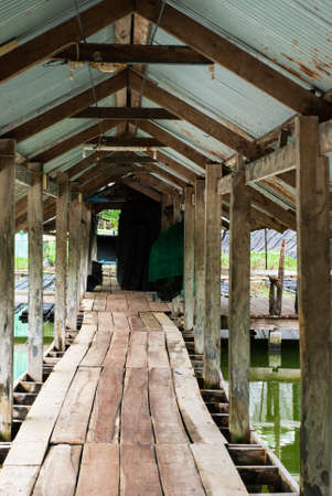 bridge across water made from planks at the soft shell crab farming の写真素材