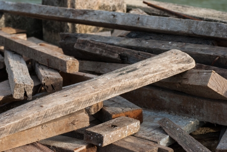 A scrap wood pile with protruding rusty nailsの写真素材