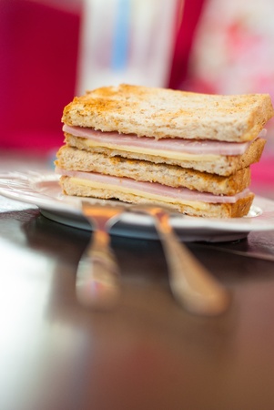 Toasted sandwich with ham and cheese on the tableの写真素材