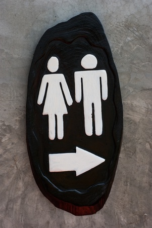 Man and Woman black wooden sign on a concrete wallの写真素材