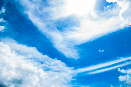 white fluffy clouds in the blue skyの写真素材