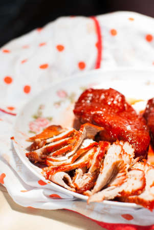 Are being sliced Roasted red pork on a cutting board の写真素材