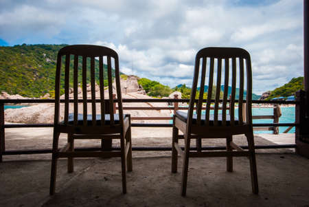 Wooden chairs on the beach at Koh Nang Yuan, Thailand の写真素材