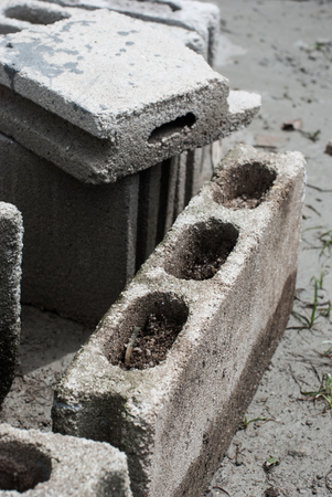 Cement blocks placed on the ground for construction.