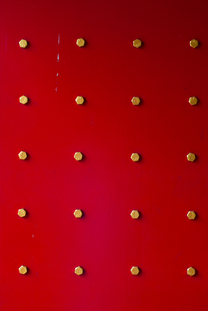 Ancient red Temple door in Ranong Thailandの写真素材