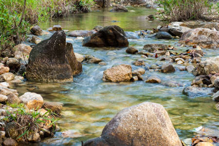 Stream flows through small rocks in the Parkの写真素材