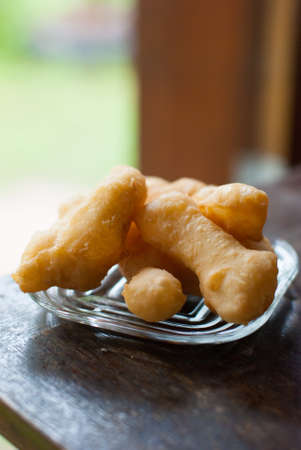 Deep fried dough stick on plate at the Cafeの写真素材