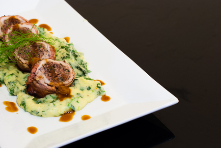 Bacon wrap pork stuff with seafood spinach mashed potato at the Restaurantの写真素材