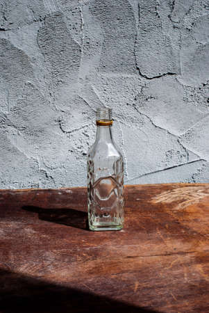 Empty bottles on the table with Cement Grey background
