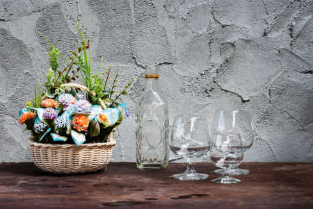 Still Life flower with differently shaped glass bottles on wooden tableの写真素材