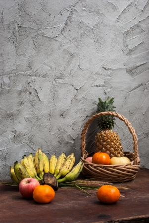 Still life with Fruits and a basket on wooden tableの写真素材