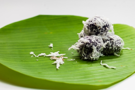 Thai dessert sweet boiled ball , roll over the grated coconut on the banana leafの写真素材
