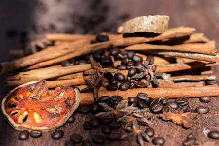 Cinnamon and coffee beans on the wooden table