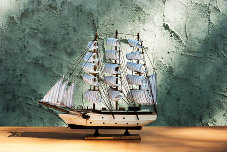 wooden sail ship toy model on the tableの写真素材