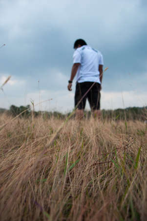 a lone man walking in the meadow at Ranong Thailandの写真素材
