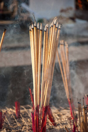 Incense sticks and smoke in ashes bucket at measuredの写真素材