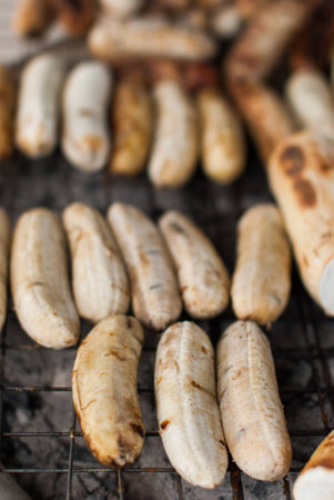 Grilled sweet potato with banana on barbecue in Thailandの写真素材