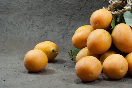 Thai Fruit , Maprang Fruit on the gray background  Close upの写真素材