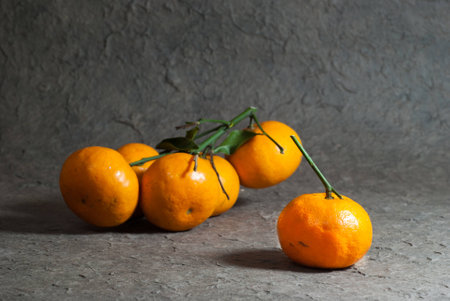 Tangerines with leaves on the gray background  Close upの写真素材