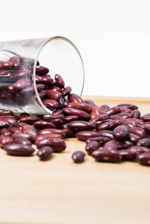 Dried red beans on a wooden tray isolated on white backgroundの写真素材