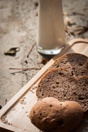 Several slices of Bread wheat and wooden chopping board , Close up