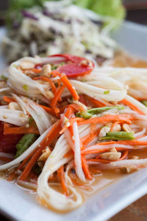 Green papaya salad on the table in the restaurant.の写真素材