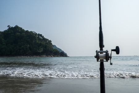 Fishing rod in sand on tropical beach,Thailandの写真素材
