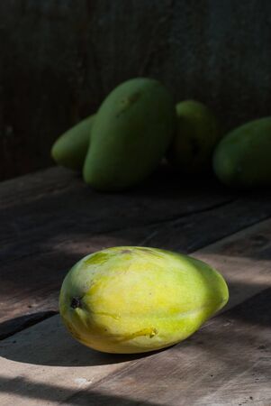 Mango fruit on a wooden table of backgroundの写真素材