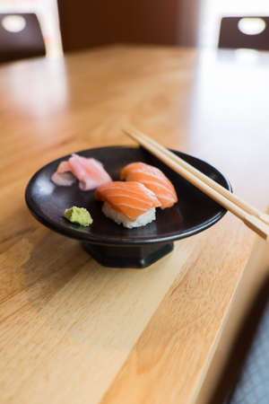 sushi salmon on Black Ceramic Plate and chopsticksの写真素材