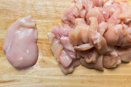raw chicken meat on a cutting board.の写真素材