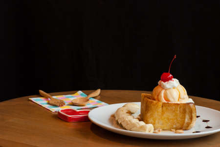 Honey toast with ice-cream and banana top cherryの写真素材