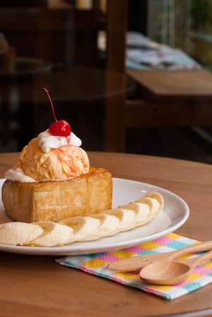 Honey toast with ice-cream and banana top cherry