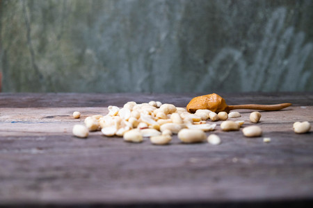 Creamy peanut butter on wood table with peanutの写真素材