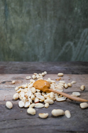 Creamy peanut butter on wood table with peanut