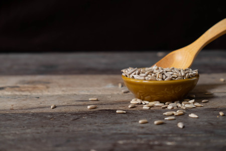 bowl of Sunflower Seeds on wooden,Dry seeds of sunflower.の写真素材