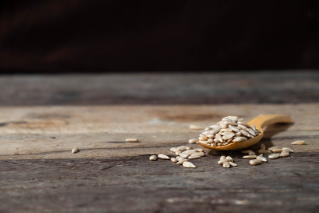bowl of Sunflower Seeds on wooden,Dry seeds of sunflower.の写真素材