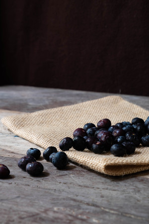 Blueberries in the bowl on wooden tableの写真素材