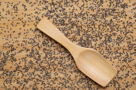 Super Food Chia seeds in a wooden spoon on the tableの写真素材