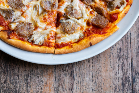 Homemade Fresh pizza with tomatoes, cheese and sausageの写真素材