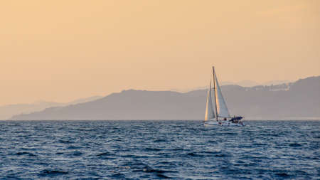 Boat in sailing regatta, Black sea at sunset, Sochi, Russiaの写真素材