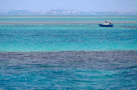 Red Sea background, clean blue water, small waves, boat, city skyline, Egyptの写真素材