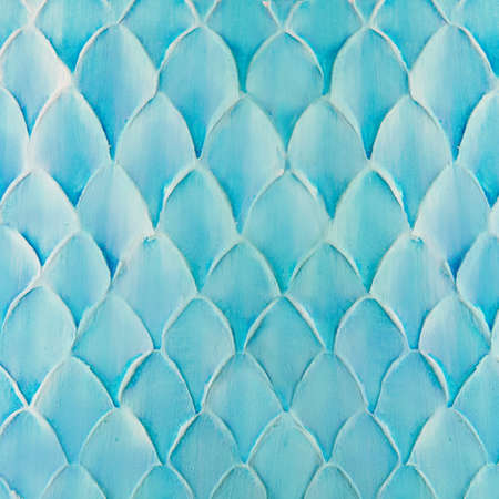 Blue decorative plaster on the wall, abstract background, imitation of scaleの写真素材