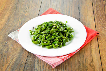 Green Beans Fried with Garlic on a White Plate.