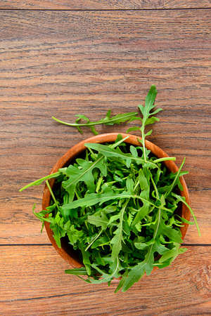 Green Arugula on Woody Background Studio Photoの写真素材