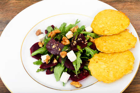 Salad of Raw Beets, Pears, Arugula, Roots, Sunflower Seeds and Cheese. Studio Photoの写真素材