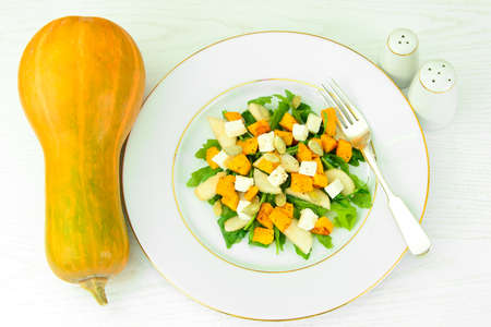 Healthy and Diet Food: Salad, Pumpkin, Pear, Cheese and Seeds Studio Photoの写真素材