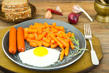 Fried Eggs with Fried Sausages and Carrots. Studio Photoの写真素材