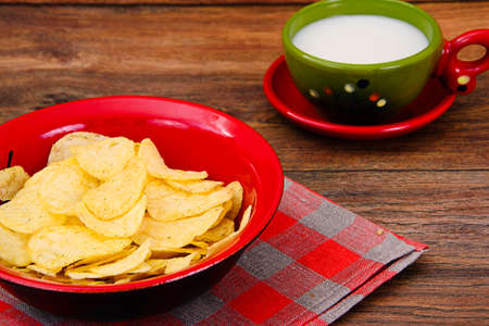 Potato Chips and Milk on Wood. Studio Photo