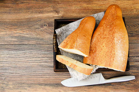 Fresh Tasty Bread on Woody Background Studio Photo